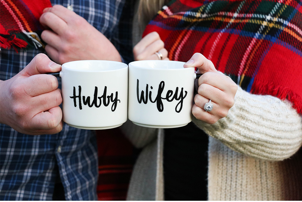 man and woman holding the cups of cocoa