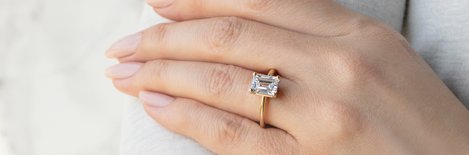 emerald cut ring on a hand